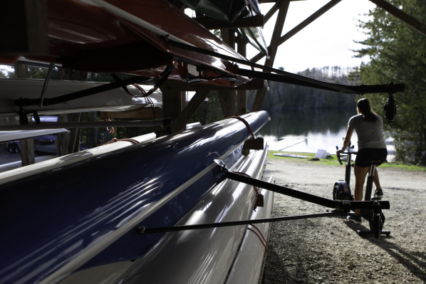 woman on bikeerg in boathouse