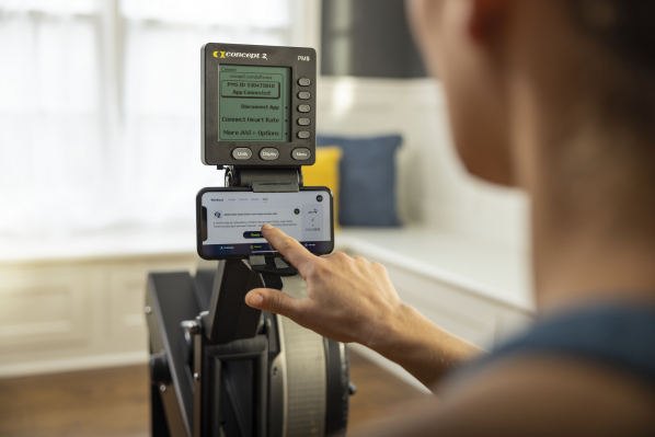 woman on rowerg pushing PM button