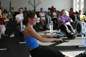 Instructor with an Indoor Rowing Class